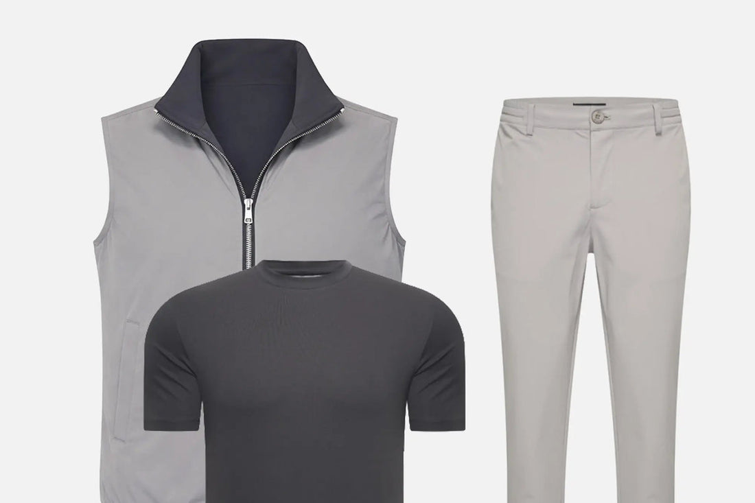 Trois pièces d'un vestiaire sobre posées à plat : gilet sans manches gris, t-shirt anthracite et pantalon sable.